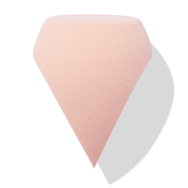 Soft pink Sculpting Sponge stands on its pointed tip, showcasing a flat top and beveled sides for precise contouring and blending on a clean white background, ideal for foundation and concealer - ColourPop Makeup Tools & Accessories.