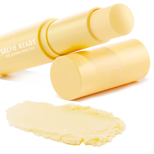 Selfie Ready pore-refining serum stick opened with twist-up balm extended, creamy pale-yellow swatch below; matte pastel-yellow tube with white geometric accents on a clean white backdrop, highlighting the ColourPop Serum Stick.