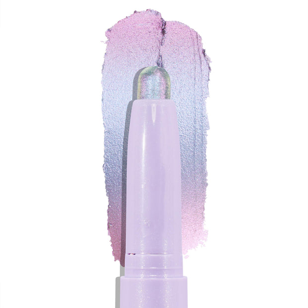 Colourpop Cotton Candy Shadow Stix crayon tip gliding upward, leaving a shimmering pastel lavender-to-pink duochrome eyeshadow swatch on a clean white background, showing smooth, blendable cream texture.