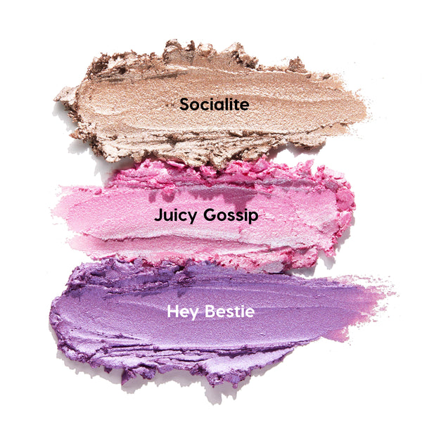 Three ColourPop Shadow Stix Cool Metallics swatches streak across a white background - Socialite (shimmery champagne), Juicy Gossip (metallic pink), and Hey Bestie (lavender purple) - showing creamy, high-shine payoff.