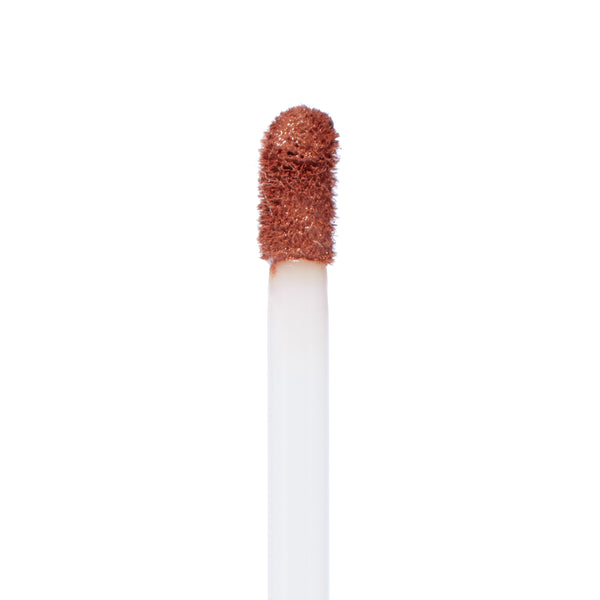 Doe-foot applicator coated in So Me Ultra Matte Lip, a warm brown nude, showcasing the velvety, long-wear ColourPop Ultra Matte Lip formula in a close-up against a clean white background.