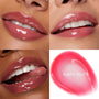 ColourPop So Juicy Plumping Glossy Lip Oil in Flirty Text coats lips with a sheer rosy pink, high-shine finish, shown in a four-panel close-up grid of lips at different angles alongside a glossy pink gel swatch labeled “FLIRTY TEXT.”