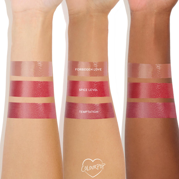 Temptation swatched on three forearms of different skin tones, the lowest glossy deep rose‑plum stripe, with nude Forbidden Love and bright Spice Level above, showcasing the high‑shine ColourPop So Juicy Plumping Gloss.