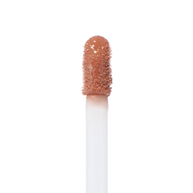 Doe-foot wand saturated with Starling Ultra Blotted Lip in a peachy nude, standing upright against a white background; ColourPop Ultra Blotted Lip applicator shown in macro, highlighting the velvety, blotted texture.