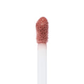 Doe-foot applicator coated in rosy nude shade Still an Icon glistens in a macro close-up, showcasing the soft-blur, semi-matte texture of the ColourPop Ultra Blotted Lip against a clean white background.