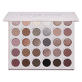 Stone Cold Fox ColourPop Shadow Palette displays 30 cool‑toned neutrals - taupes, mauves, grays, and charcoals - in matte and shimmer finishes, arranged in rows inside a white rectangular case with a soft pink lid and printed shade names.
