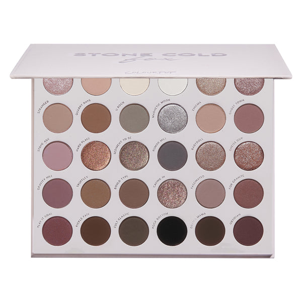 Stone Cold Fox ColourPop Shadow Palette displays 30 cool‑toned neutrals - taupes, mauves, grays, and charcoals - in matte and shimmer finishes, arranged in rows inside a white rectangular case with a soft pink lid and printed shade names.
