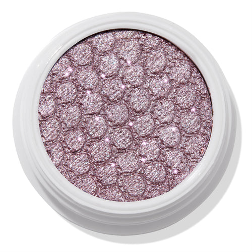 ColourPop The Griffith Super Shock Shadow eyeshadow showing a metallic cool-toned lavender-pink shimmer, pressed with a quilted honeycomb texture in a white round pot, reflecting silver sparkles for high-shine lids.