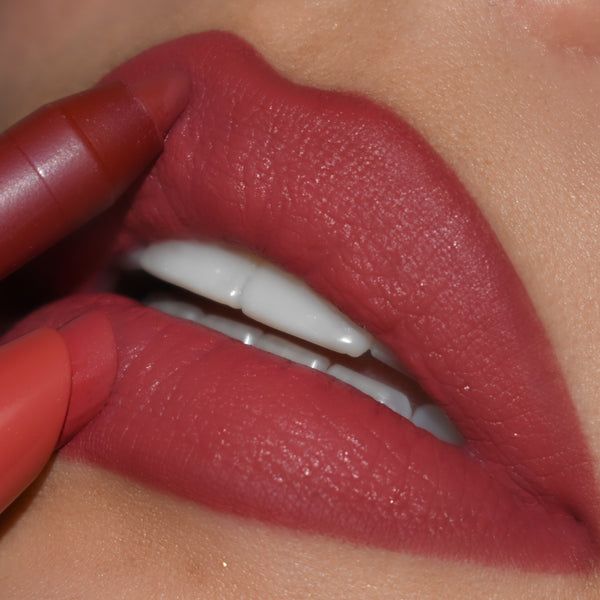 ColourPop Lippie Pencil in Bumble precisely lines full lips, the warm rose-mauve shade gliding along the cupid’s bow and lower lip for a smooth, matte finish in a close-up beauty shot.
