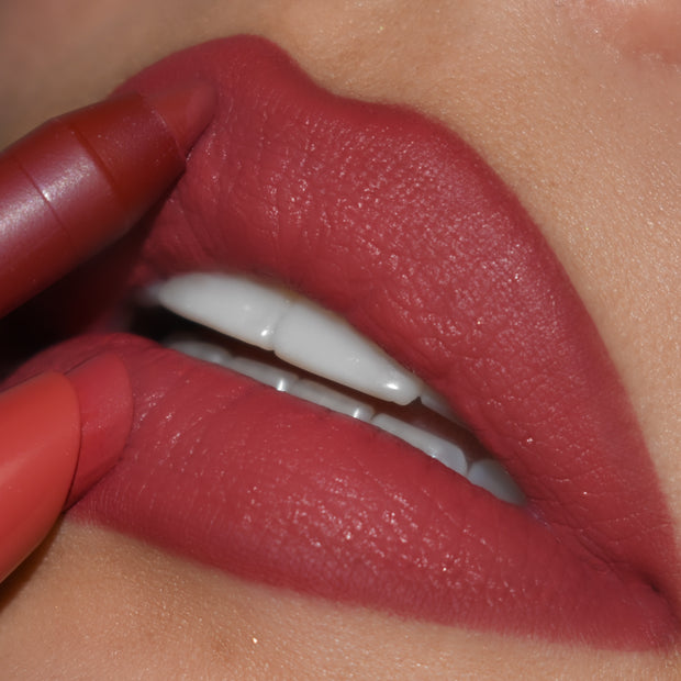 ColourPop Lippie Pencil in Bumble precisely lines full lips, the warm rose-mauve shade gliding along the cupid’s bow and lower lip for a smooth, matte finish in a close-up beauty shot.