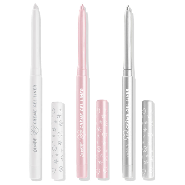 Total Essentials ColourPop Crème Gel Liner trio stands uncapped, displaying retractable tips in white, soft pink, and metallic silver with matching doodle-print caps alongside, studio-lit on a white background.