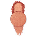 Turntables pan gleams with warm peach‑coral, gold‑fleck shimmer, a circular ColourPop Pressed Powder Shadow shown with a crushed swatch above and below on a clean white background.
