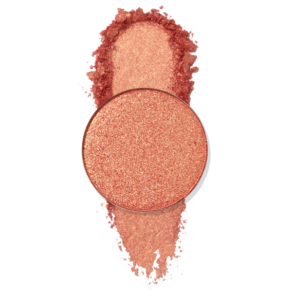Turntables pan gleams with warm peach‑coral, gold‑fleck shimmer, a circular ColourPop Pressed Powder Shadow shown with a crushed swatch above and below on a clean white background.