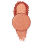 Turntables pan gleams with warm peach‑coral, gold‑fleck shimmer, a circular ColourPop Pressed Powder Shadow shown with a crushed swatch above and below on a clean white background.