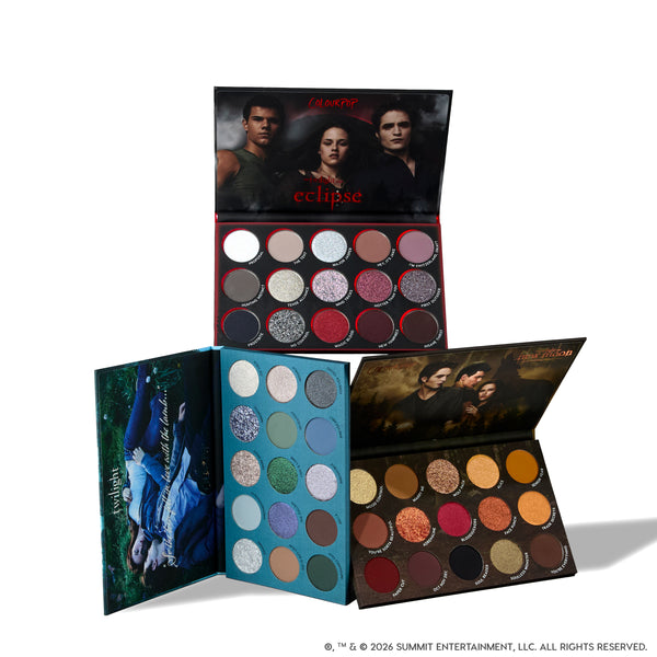 Twilight Forever palette trio displayed open, showing three Twilight-themed ColourPop eyeshadow palettes with rows of shimmery silvers, bold reds, earthy browns, greens, and blues, each compact featuring iconic Twilight movie artwork on the covers.