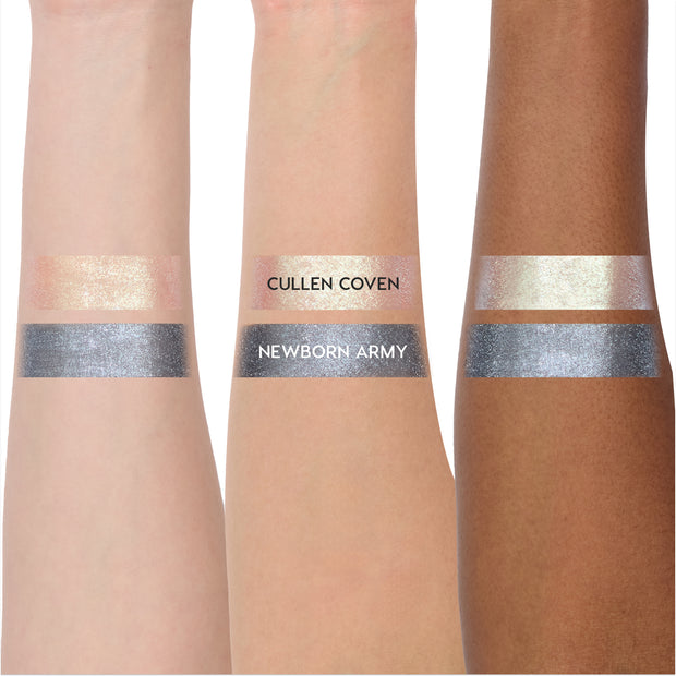 Coven Clash Jelly Much Duo Twilight collection swatched on three arms, showing shimmery pale gold Cullen Coven and metallic steel gray Newborn Army shades with opaque, reflective payoff across light to deep skin tones.