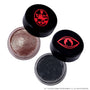 Coven Clash Jelly Much Duo Twilight makeup set showing two open gel eyeshadows, one shimmery rose gold and one sparkly charcoal black, in clear pots with black lids featuring bold red Twilight-inspired crest and eye symbols on a white background.