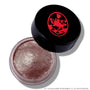 Open ColourPop Cullen Coven Jelly Much Shadow, a shimmery metallic taupe cream eyeshadow inspired by Twilight, sits in a clear round jar with a tilted black lid featuring a bold red crest logo on a white background.