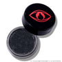 Open pot of ColourPop Newborn Army Jelly Much Shadow showing deep charcoal black, shimmer-packed cream eyeshadow, with the Twilight-inspired black lid featuring a bold red eye and flame icon resting beside it on a white background.