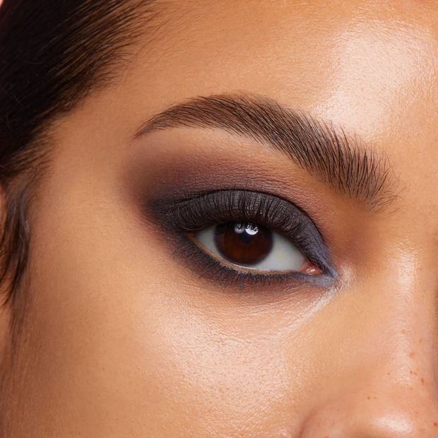 Close-up brown eye showcases a charcoal-to-mocha smoky lid with tightlined lower lash and soft matte blend, created with the Twilight ColourPop Shadow Palette, highlighting precise blending, defined lashes, and a seamless gradient in studio light.