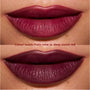 Close-up lips wearing Newborn powder to creme lipstick from the Twilight collection, showing buildable color shifting from rich wine to deep blood-red with a smooth, satin finish on medium skin tone.