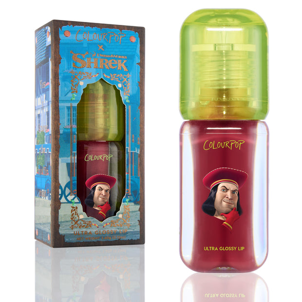 Short Lord ColourPop Ultra Glossy Lip tube stands upright showing deep red gloss in a clear bottle with lime-green cap and Lord Farquaad graphic, placed beside the Shrek collaboration box on a white background.