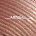 Flynn Rider Ultra Glossy Lip swatch shows a warm nude gloss with silver‑gold shimmer, spread in wavy ripples for a high‑shine finish; close-up of the ColourPop Ultra Glossy Lip shade on a textured smear.