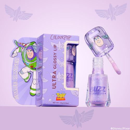 ColourPop Ultra Glossy Lip Buzzin' About, a lavender shimmery gloss, shown open with doe-foot applicator above the bottle, featuring Buzz Lightyear graphics on the cap and box with Disney Pixar Toy Story branding against a purple backdrop.