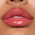 Glossy pink lips showcasing ColourPop Ultra Glossy Lip, shade Experiment 626, catching bright studio light with a glassy finish in a tight close-up beauty swatch.