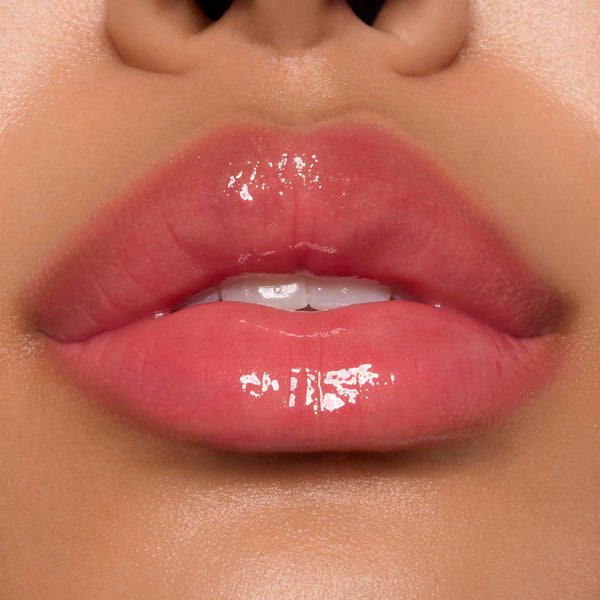 Glossy pink lips showcasing ColourPop Ultra Glossy Lip, shade Experiment 626, catching bright studio light with a glassy finish in a tight close-up beauty swatch.