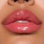 Glossy pink lips showcasing ColourPop Ultra Glossy Lip, shade Experiment 626, catching bright studio light with a glassy finish in a tight close-up beauty swatch.