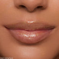 Lips wearing ColourPop Ultra Glossy Lip Pascal, catching studio light in a sheer, high-shine finish with fine iridescent shimmer; extreme close-up beauty shot emphasizing smooth, hydrated lips and glossy payoff.