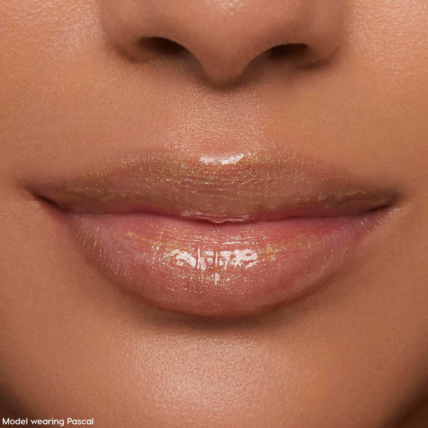Lips wearing ColourPop Ultra Glossy Lip Pascal, catching studio light in a sheer, high-shine finish with fine iridescent shimmer; extreme close-up beauty shot emphasizing smooth, hydrated lips and glossy payoff.
