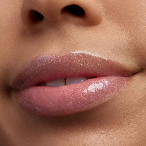 Glossy, shimmer-packed lips wearing ColourPop Ultra Glossy Lip in Peep This, catching light with a sheer pink, high-shine finish and fine iridescent sparkle, shown in a studio macro close-up of the lower face for product color and texture detail.