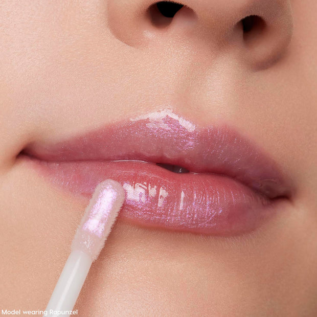Close-up of a model applying shimmery pink Ultra Glossy Lip from the Disney Tangled and ColourPop Collection full collection set, showing high-shine finish on lips with the Back In Stock ColourPop gloss wand in use.