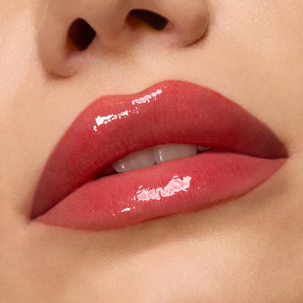 Glossy lips showcasing ColourPop Ultra Glossy Lip, Runs with Vampires, reflecting high-shine berry-red pigment with subtle shimmer; macro lip swatch in studio lighting highlighting a smooth, lacquered finish.