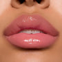 Glossy pink lips wearing ColourPop Ultra Glossy Lip in Super Sweet, showcasing a sheer warm pink tint with a glassy, high-shine finish in a studio close-up, highlighting smooth, hydrated texture and precise application.