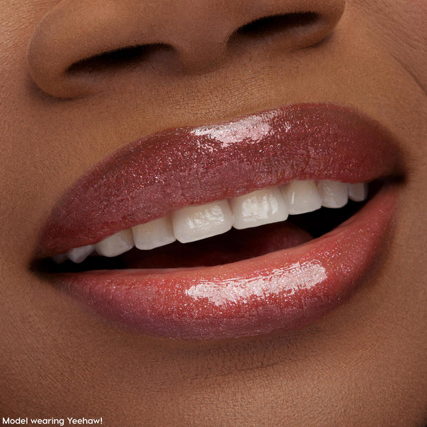 Glossy lips wearing ColourPop Ultra Glossy Lip in Squad Dreams, slightly parted with a soft smile, showcasing a high-shine, sheer rosy tint and fine shimmer in a tight beauty close-up with smooth, hydrated coverage.