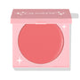 Whole Mood cream blush showing a warm coral shade as the pink compact with ColourPop logo sits half-open, revealing the round pan and star accents; studio close-up on white for ColourPop Cream Blush shoppers seeking a soft, natural flush.