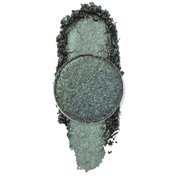 ColourPop Wishful Winking pressed powder shadow, a metallic blue‑green teal pan with crushed, foiled shimmer, shown swatched and crumbled on a white background to display its high-shine payoff and cool-toned sparkle.