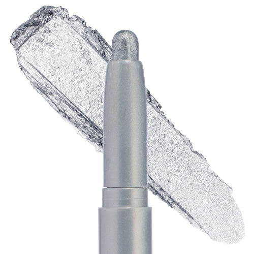 ColourPop Shadow Stix in Witch, Please gliding a cool‑toned silver metallic swatch, shown in a macro close‑up on a white background, featuring a rounded twist‑up cream eyeshadow tip with high‑shine foil shimmer.