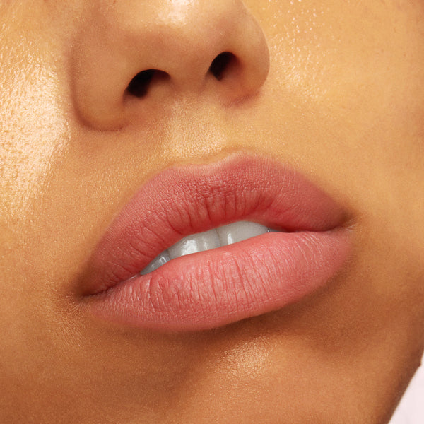 Softly tinted lips wearing Mood 24/7 from the ColourPop Cheek & Lip Set, showing a rosy nude, blurred-matte finish as the mouth gently parts, captured in an extreme close-up against dewy skin for a natural everyday look.