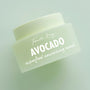 Avocado Superfood Face Mask by Fourth Ray Beauty, a ColourPop Face Mask, resting at a slight angle; pale green frosted jar with white script logo and bold AVOCADO text on a soft mint background.