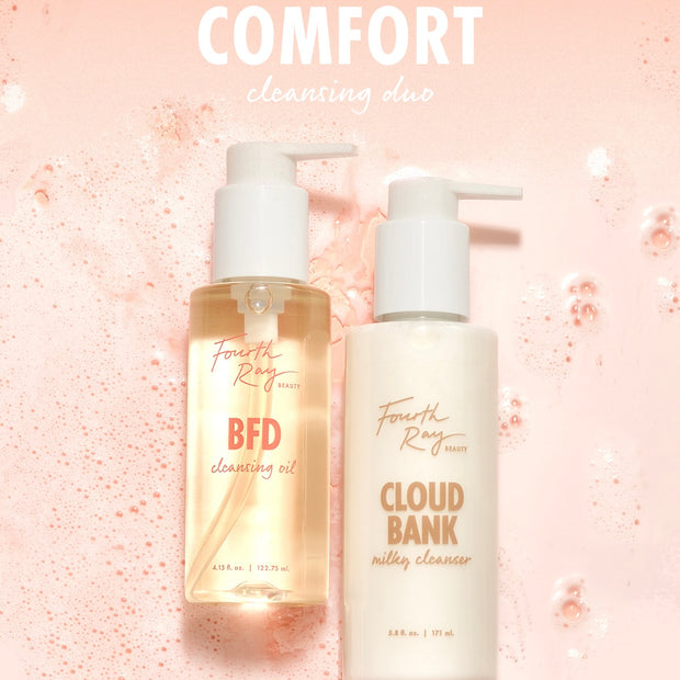 Fourth Ray Beauty Cloud Bank Milky Cleanser (5.8 fl oz) pump bottle stands beside BFD Cleansing Oil (4.15 fl oz) on a pink, foamy backdrop, showcasing a comforting cleansing duo; gentle ColourPop Face Cleanser for daily use.