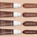 ColourPop Pretty Fresh Tinted Moisturizer in Deep Dark 23 N - third swatch in a row - shown alongside deep shades 21W, 22N, and 24N next to four pump bottles, highlighting the hyaluronic acid formula on a beige background.
