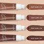 ColourPop Pretty Fresh Tinted Moisturizer in Deep Dark 23 N - third swatch in a row - shown alongside deep shades 21W, 22N, and 24N next to four pump bottles, highlighting the hyaluronic acid formula on a beige background.