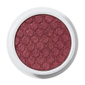 ColourPop Drift Super Shock Shadow displays a metallic cranberry-burgundy shimmer, pressed with a quilted scale pattern, sitting in a round white pot on a plain white studio background.