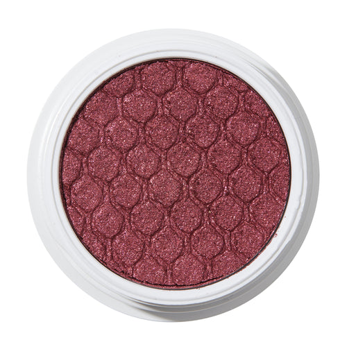 ColourPop Drift Super Shock Shadow displays a metallic cranberry-burgundy shimmer, pressed with a quilted scale pattern, sitting in a round white pot on a plain white studio background.