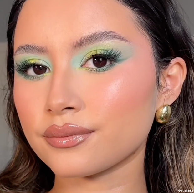 Mint and teal gradient eye look created with the Just My Luck ColourPop Shadow Palette, shown in a close-up of a model with fluttery lashes, glossy nude lips, and a gold hoop earring under soft indoor light, showcasing bold green pigment.