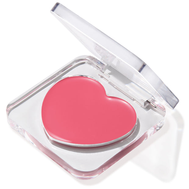 Adore You ColourPop Lip and Cheek Balm - heart-shaped rosy pink balm pan - sits in a clear square compact with a hinged lid half open, angled on a white background, highlighting the multiuse tint for lips and cheeks.